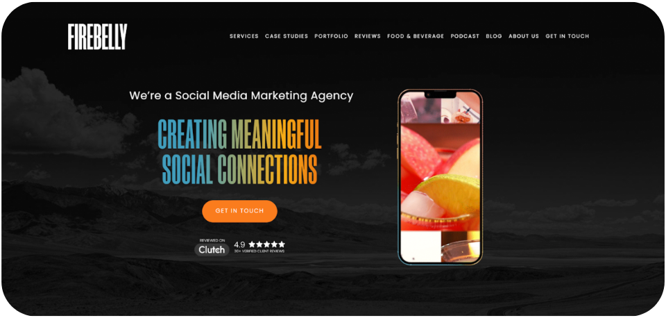 Firebelly website homepage showcasing its social media marketing services with the tagline 'Creating Meaningful Social Connections,' featuring a smartphone displaying vibrant fruit visuals against a dark landscape background.