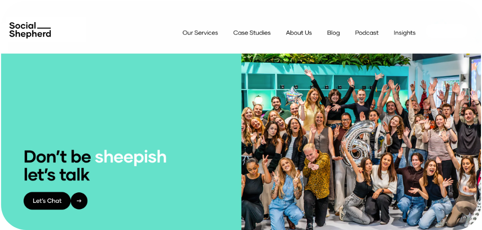 Social Shepherd Agency website homepage showcasing a bright group photo of their employees with the tagline ‘Don’t be sheepish. Let’s talk!’ against a teal background.