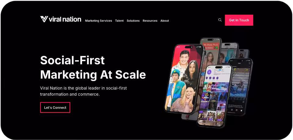 Viral Nation Agency website homepage showcasing its social media marketing services with the tagline 'A creative-first social agency’
featuring a mobile phones displaying vibrant social media ad visuals against a black background.
