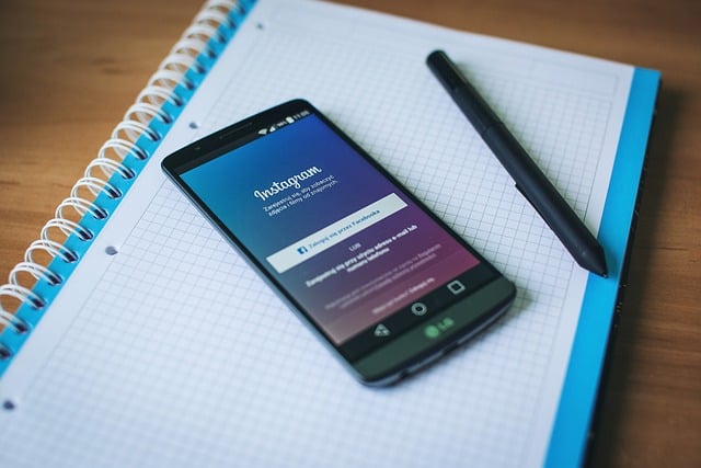 A mobile on a notepad with important Instagram Usage statistics