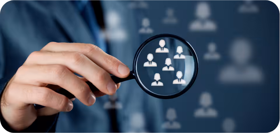 Business professional holding a magnifying glass over digital user icons, representing targeted audience segmentation and custom audiences for TikTok marketing and social media advertising.