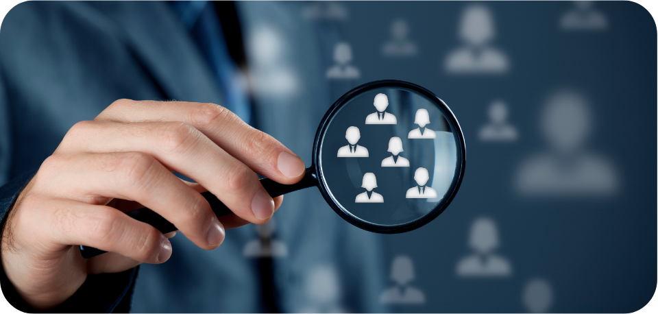 Business professional holding a magnifying glass over digital user icons, representing targeted audience segmentation and custom audiences for TikTok marketing and social media advertising.